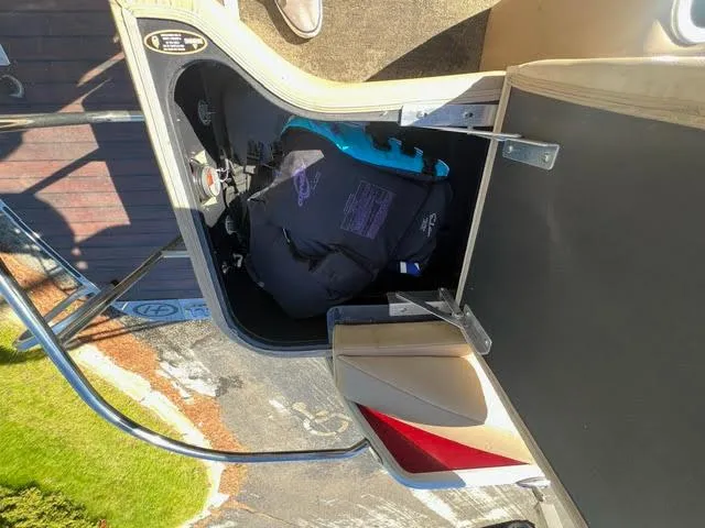 Slide: The Image of 2014 Harris FloteBote Grand Mariner 250 storage compartment with life jackets. - 16