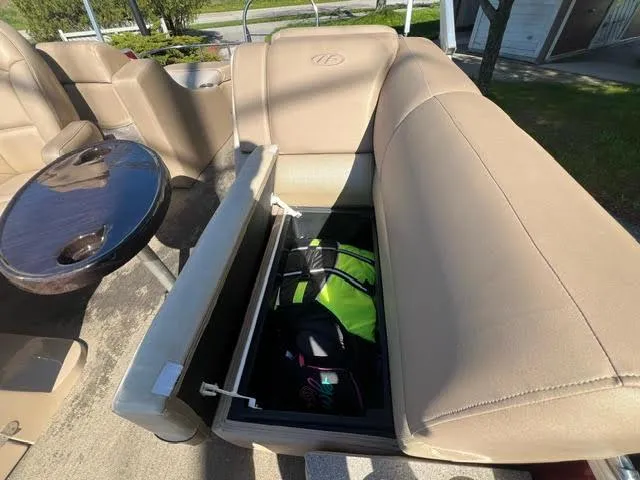 Slide: The Image of 2014 Harris FloteBote Grand Mariner 250 boat with open storage compartment. - 23