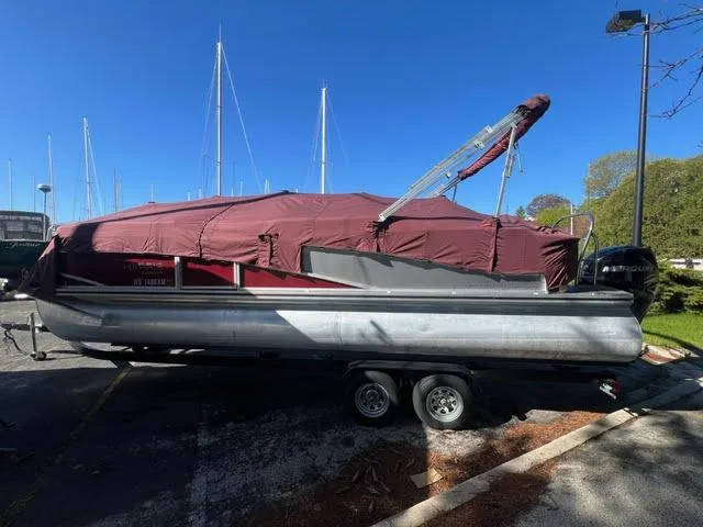 Slide: The Image of 2014 Harris FloteBote Grand Mariner 250 pontoon boat with maroon cover on trailer. - 3
