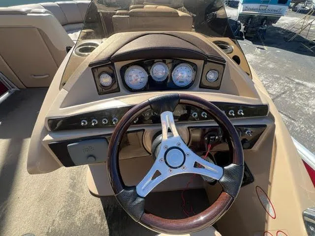 Slide: The Image of 2014 Harris FloteBote Grand Mariner 250 boat dashboard with steering wheel and gauges. - 35