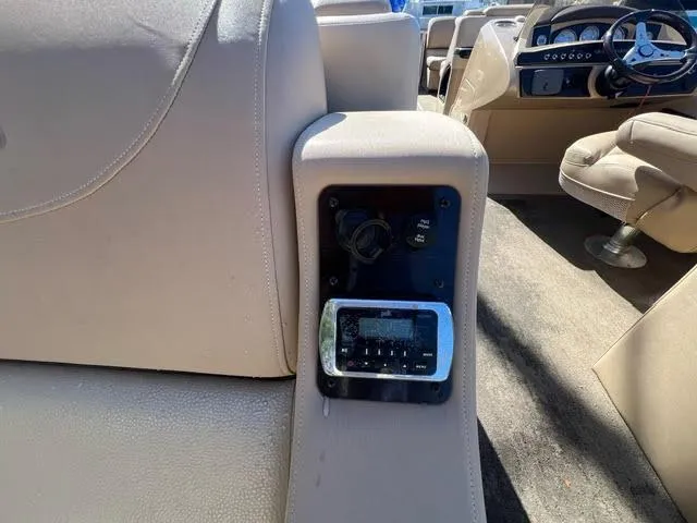 Slide: The Image of 2014 Harris FloteBote Grand Mariner 250 interior, beige seating, control panel close-up. - 39