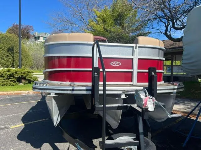 Slide: The Image of 2014 Harris FloteBote Grand Mariner 250 pontoon boat on trailer in parking lot. - 4