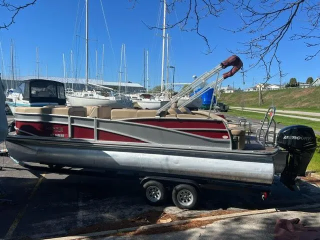 Slide: The Image of 2014 Harris FloteBote Grand Mariner 250 pontoon boat on trailer in marina. - 9