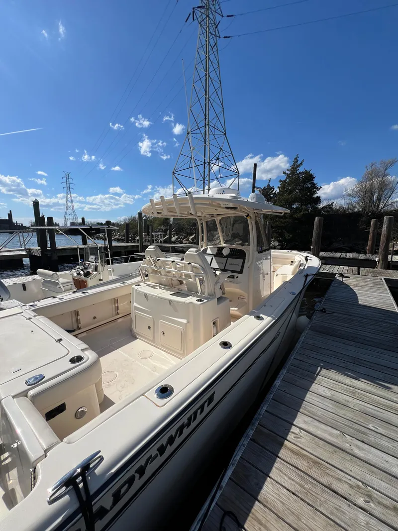 Slide: The Image of 2019 Grady-White Canyon 306 boat docked under clear blue sky. - 28