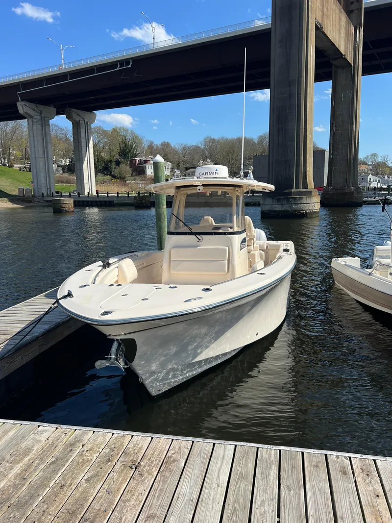 Slide: The Image of 2019 Grady-White Canyon 306 boat docked under a bridge on a sunny day. - 3