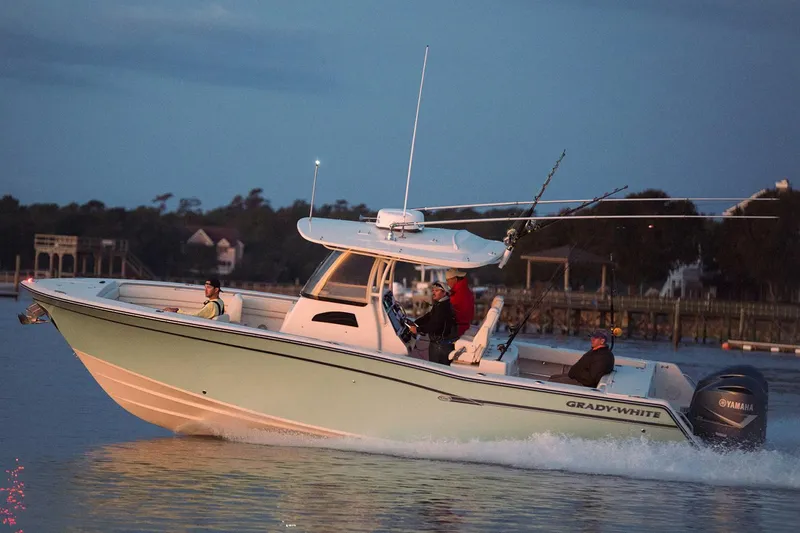 Slide: The Image of 2019 Grady-White Canyon 306 boat cruising on calm waters at dusk. - 31