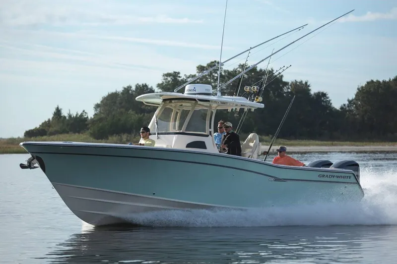 Slide: The Image of 2019 Grady-White Canyon 306 boat cruising on water with fishing rods. - 33