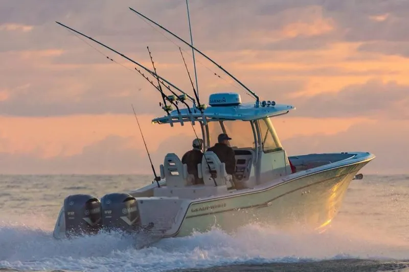 Slide: The Image of 2019 Grady-White Canyon 306 boat cruising at sunset with fishing rods. - 34