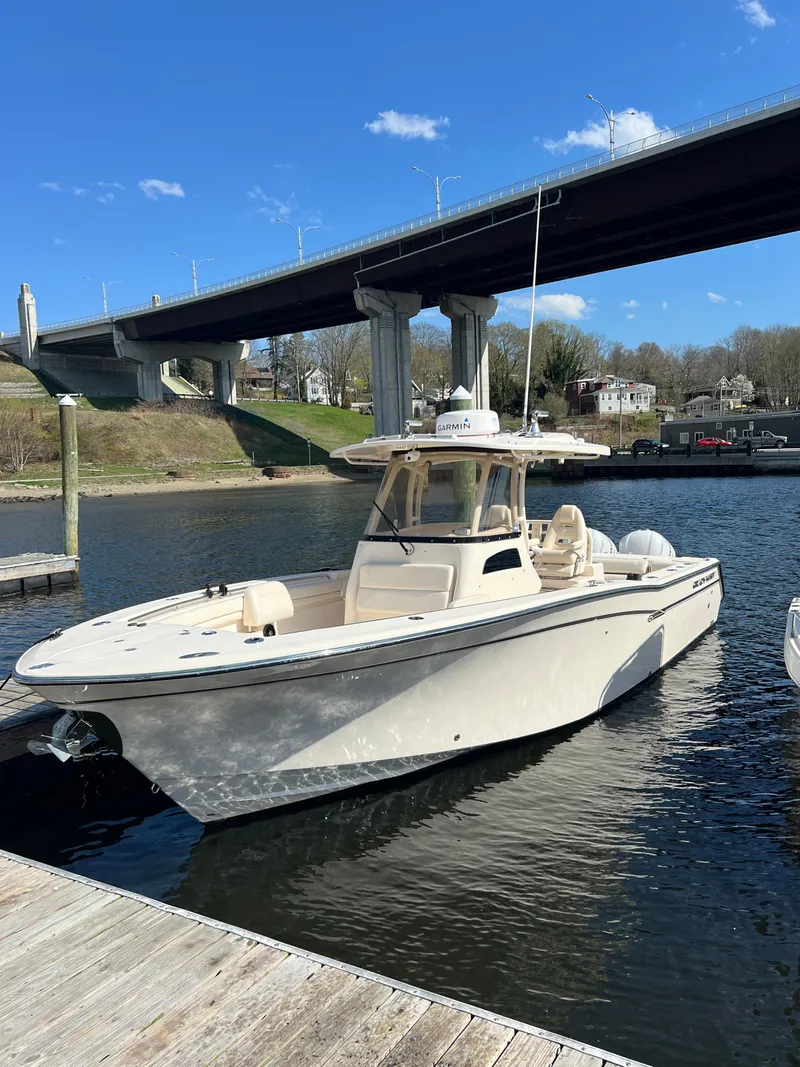 Slide: The Image of 2019 Grady-White Canyon 306 boat docked under a bridge on a sunny day. - 4