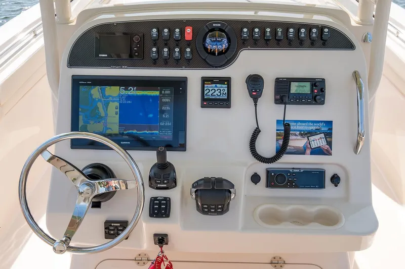 Slide: The Image of Control panel of 2019 Grady-White Canyon 306 boat with navigation and communication equipment. - 40