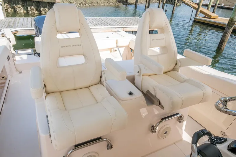 Slide: The Image of 2019 Grady-White Canyon 306 boat seats, luxurious white leather, dockside view. - 41