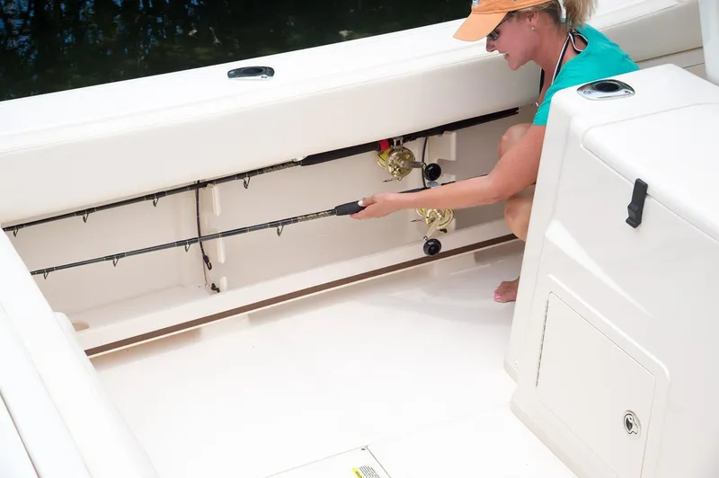 Slide: The Image of Woman storing fishing rod on 2019 Grady-White Canyon 306 boat. - 46