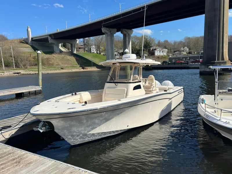 Slide: The Image of 2019 Grady-White Canyon 306 boat docked under a bridge on a sunny day. - 5