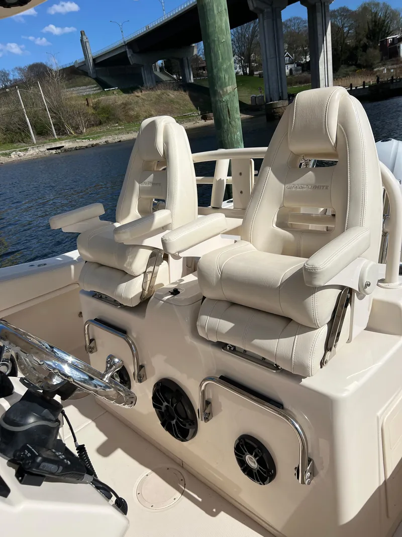Slide: The Image of 2019 Grady-White Canyon 306 boat interior with luxurious seating and steering wheel. - 7