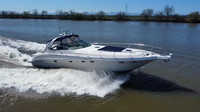 The Image of 2001 Sea Ray 460 Sundancer cruising on a calm river. - 0