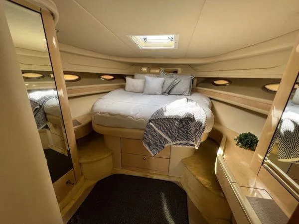 Slide: The Image of Luxurious bedroom interior of 2001 Sea Ray 460 Sundancer yacht with cozy bed and skylight. - 10