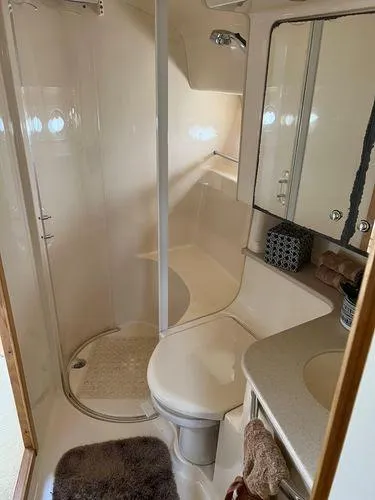 Slide: The Image of 2001 Sea Ray 460 Sundancer bathroom with shower, toilet, and vanity. - 11