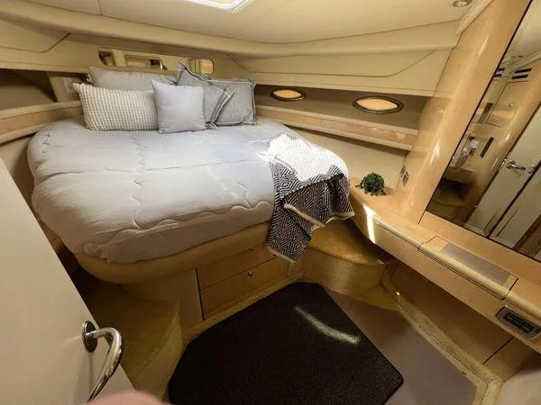 Slide: The Image of Luxurious bedroom interior of 2001 Sea Ray 460 Sundancer yacht with cozy bed and elegant decor. - 12