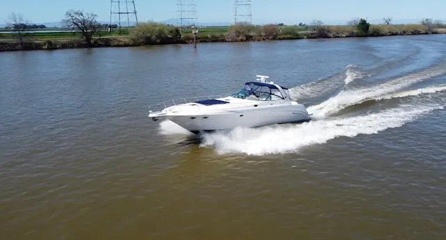 Slide: The Image of 2001 Sea Ray 460 Sundancer cruising on a river. - 26