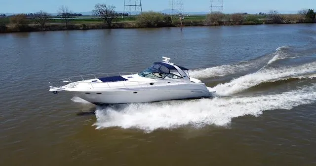 Slide: The Image of 2001 Sea Ray 460 Sundancer cruising on a river. - 27