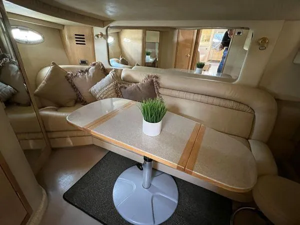 Slide: The Image of Interior of 2001 Sea Ray 460 Sundancer yacht with beige seating and dining table. - 3