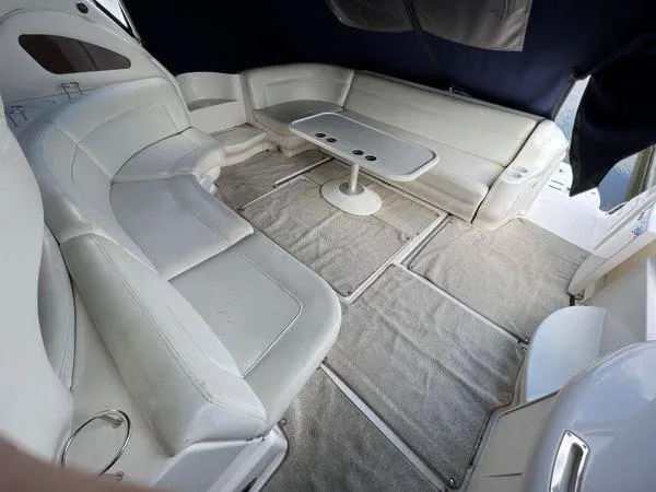 Slide: The Image of 2001 Sea Ray 460 Sundancer interior with white leather seating and table. - 32
