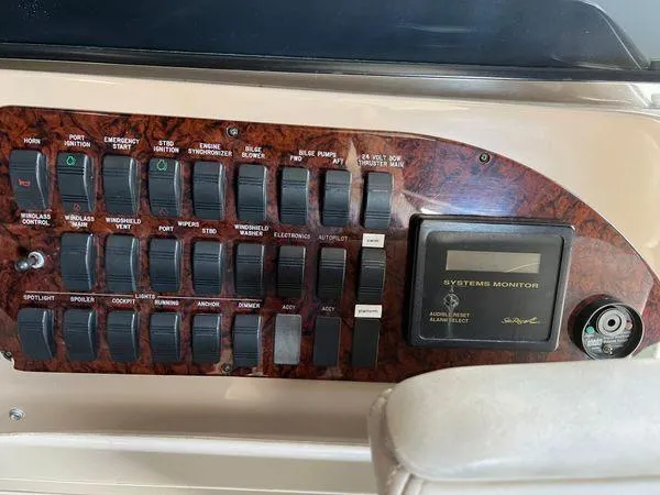Slide: The Image of Control panel of a 2001 Sea Ray 460 Sundancer yacht with various switches and systems monitor. - 35