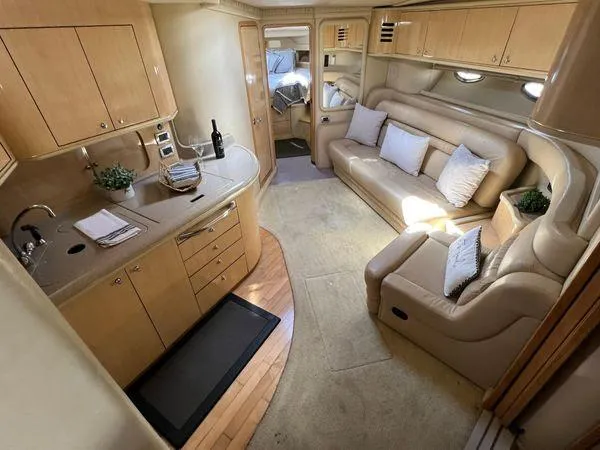 Slide: The Image of Luxurious interior of 2001 Sea Ray 460 Sundancer yacht with kitchen and seating area. - 36