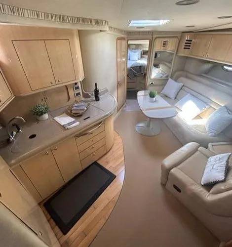 Slide: The Image of Interior of 2001 Sea Ray 460 Sundancer yacht with kitchen and lounge area. - 37