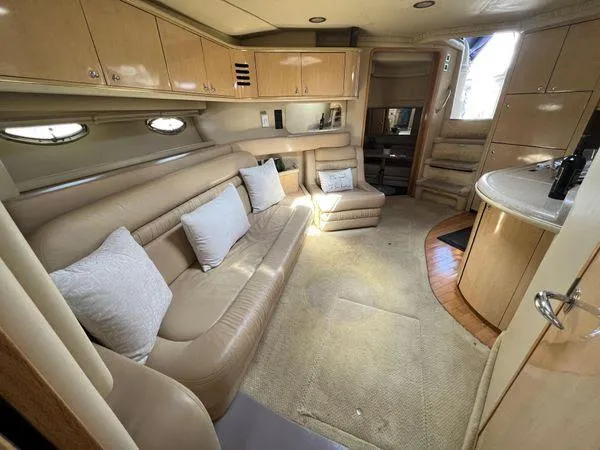 Slide: The Image of Interior of 2001 Sea Ray 460 Sundancer yacht with beige leather seating and modern amenities. - 38