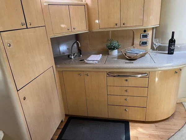 Slide: The Image of 2001 Sea Ray 460 Sundancer kitchen with wooden cabinets and countertop. - 5