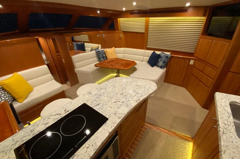 Slide: The Image of Luxurious interior of 2026 Mikelson 45 Gen III Sportfish yacht with modern seating and kitchen. - 2