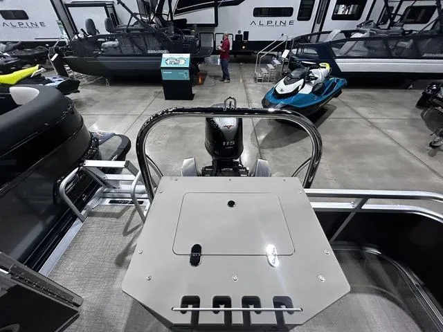 Slide: The Image of 2024 Avalon Venture Fish N Cruise 21 FT boat displayed indoors with motor and deck view. - 11