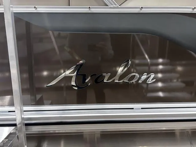 Slide: The Image of 2024 Avalon Venture Fish N Cruise 21 FT boat with sleek design and logo. - 4