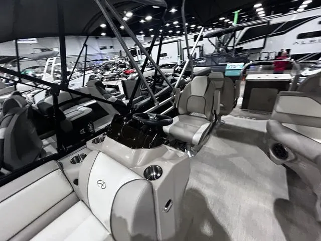 Slide: The Image of 2024 Avalon Venture Fish N Cruise 21 FT interior at a boat show. - 9