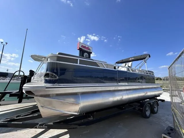 Slide: The Image of 2024 Avalon Venture Quad Lounger 23 FT pontoon boat, blue and gray. - 1
