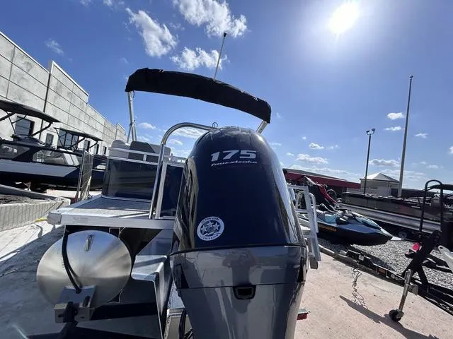 Slide: The Image of 2024 Avalon Venture Quad Lounger 23 FT with 175 horsepower engine, docked under sunny skies. - 14