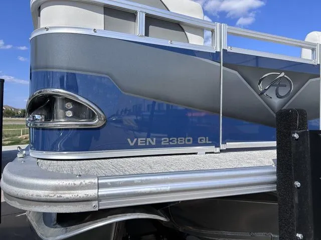Slide: The Image of 2024 Avalon Venture Quad Lounger 23 FT pontoon boat, blue and gray exterior. - 4