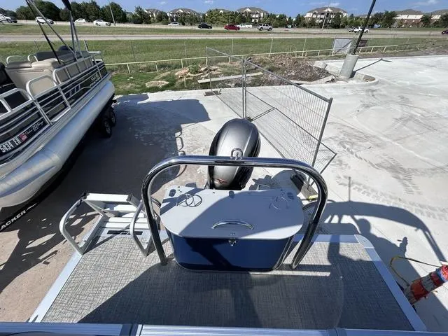 Slide: The Image of 2024 Avalon Venture Quad Lounger 23 FT pontoon boat, rear view with motor and railing. - 9