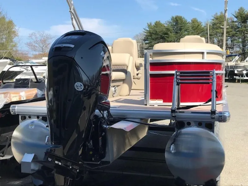Slide: The Image of 2024 Sun Tracker PB 22 DLX pontoon boat with outboard motor and red exterior. - 10