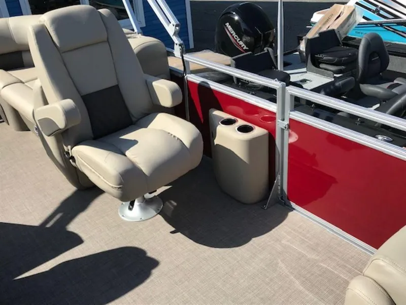 Slide: The Image of 2024 Sun Tracker PB 22 DLX pontoon boat interior with beige seating and red side panel. - 11