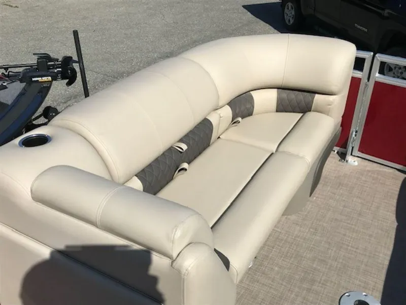 Slide: The Image of 2024 Sun Tracker PB 22 DLX pontoon boat with beige cushioned seating. - 13