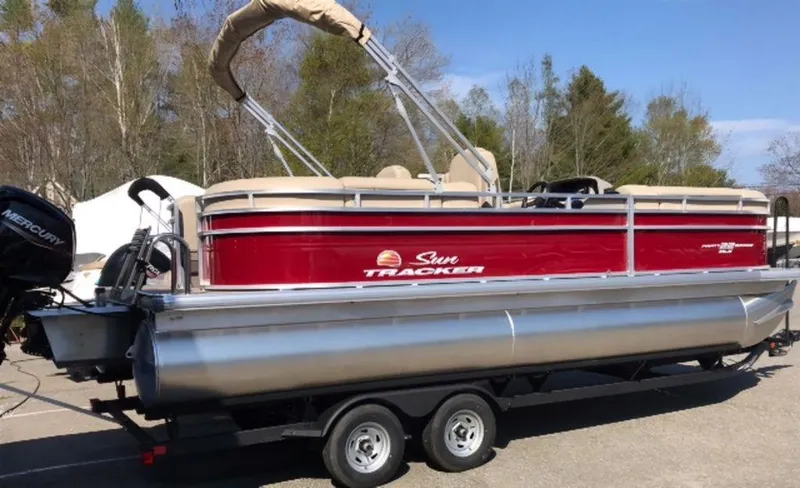 Slide: The Image of 2024 Sun Tracker PB 22 DLX pontoon boat on trailer, red and silver. - 4