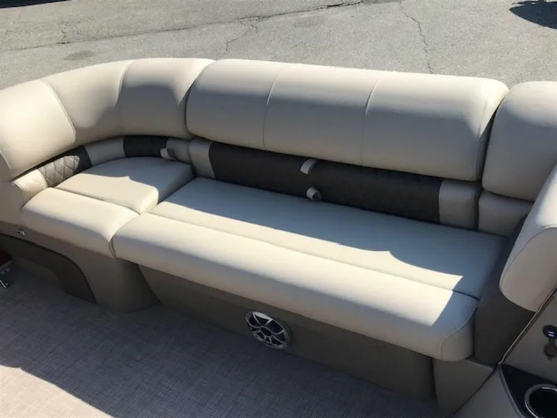Slide: The Image of 2024 Sun Tracker PB 22 DLX pontoon boat seating area with beige upholstery. - 5