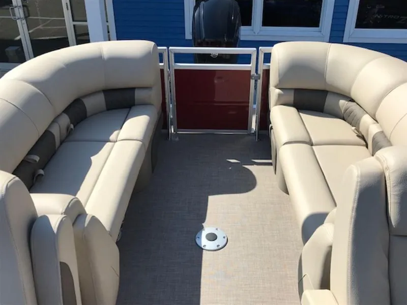 Slide: The Image of 2024 Sun Tracker PB 22 DLX pontoon boat interior with beige seating. - 6