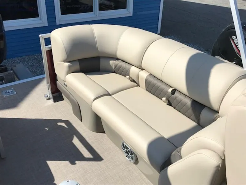 Slide: The Image of 2024 Sun Tracker PB 22 DLX pontoon boat with beige seating and speaker system. - 7