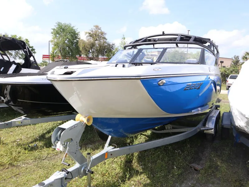 Slide: The Image of 2024 Yamaha Boats 222XE on trailer, blue and white exterior. - 1