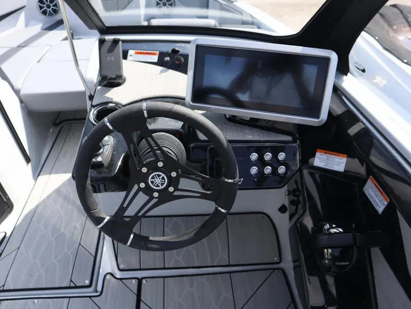 Slide: The Image of 2024 Yamaha Boats 222XE cockpit with steering wheel and touchscreen display. - 3