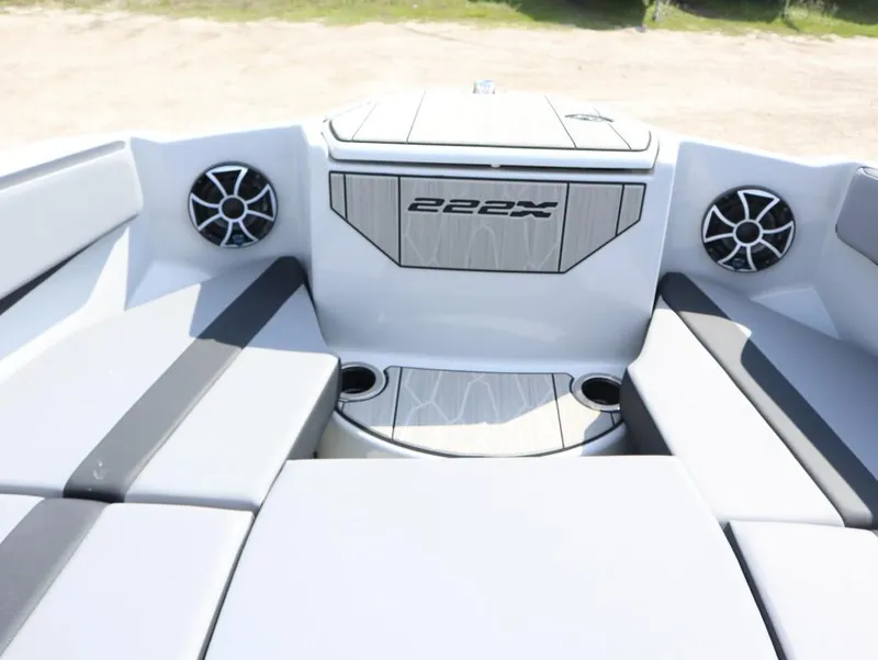 Slide: The Image of Interior seating of 2024 Yamaha Boats 222XE with speakers and cup holders. - 6
