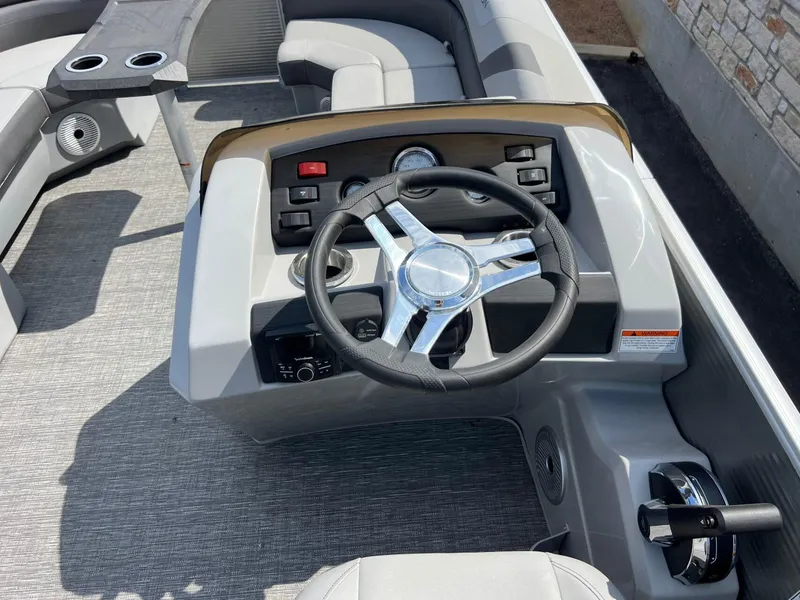 Slide: The Image of Steering console of 2024 Bennington 22S pontoon boat with modern controls and seating. - 12
